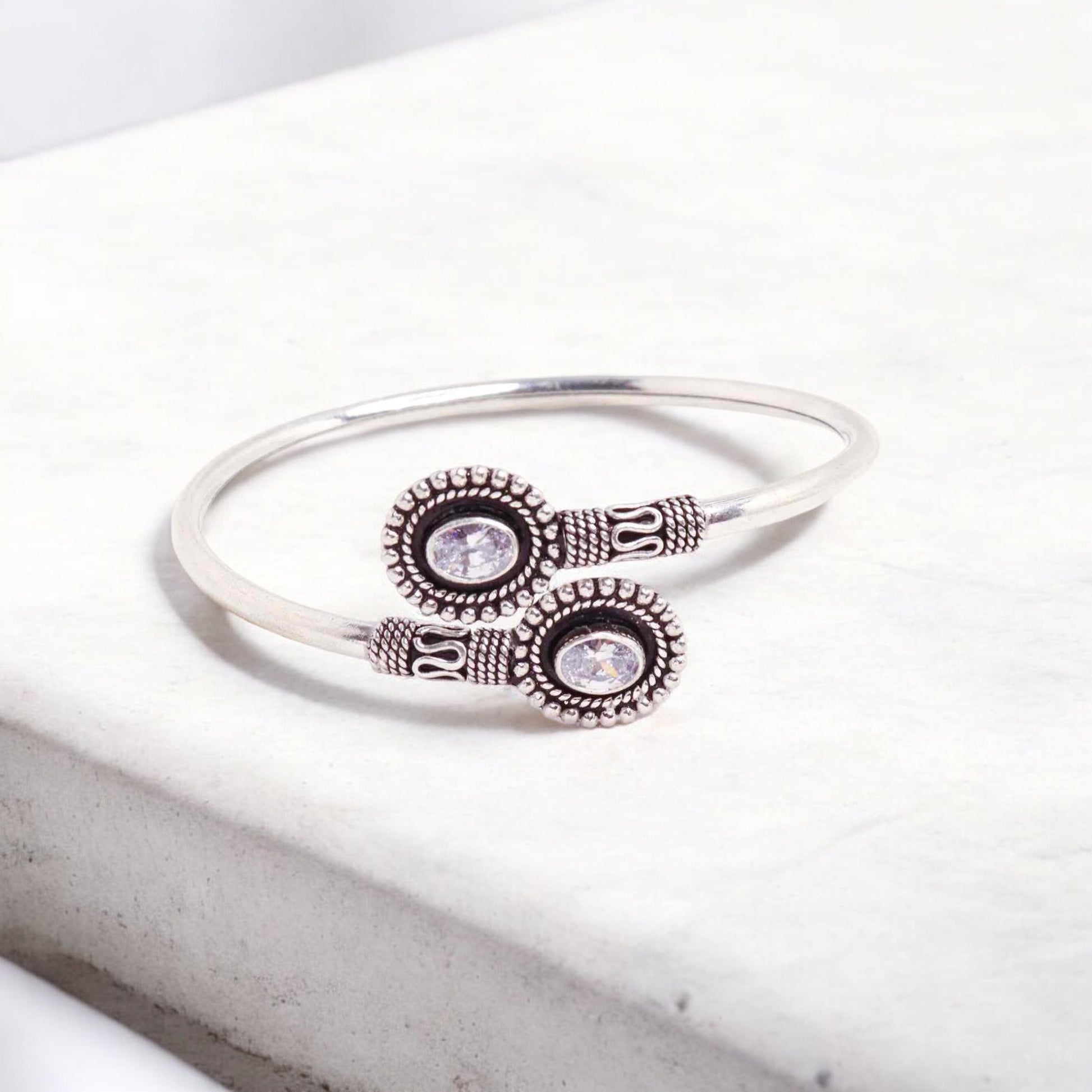 Elegant silver hand cuff or bracelet for women, featuring a sleek and sophisticated design, perfect for adding a touch of refinement to any outfit.

