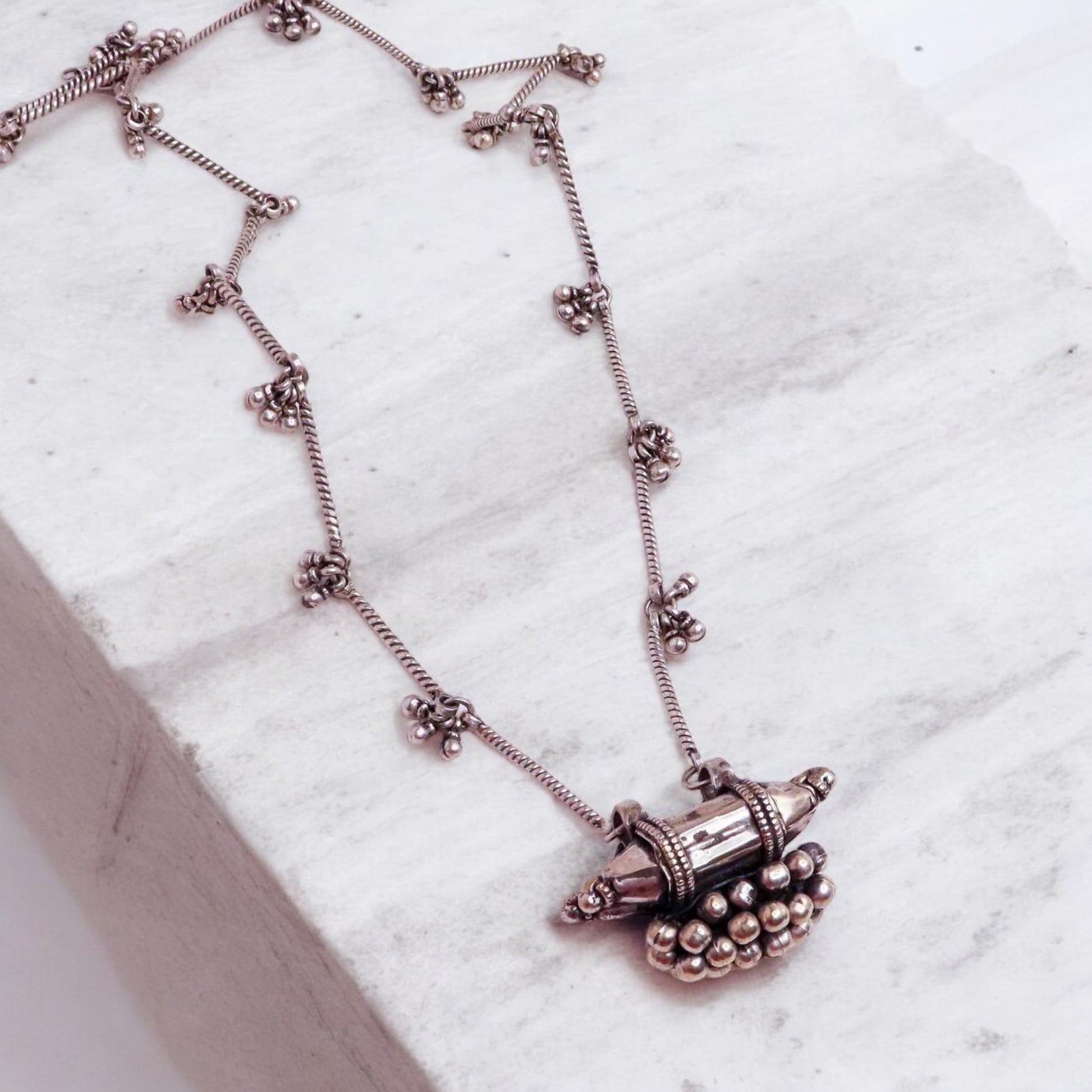 Striking oxidized silver necklace with detailed vintage-inspired patterns, offering a bold, unique look with a timeless, antique finish.
