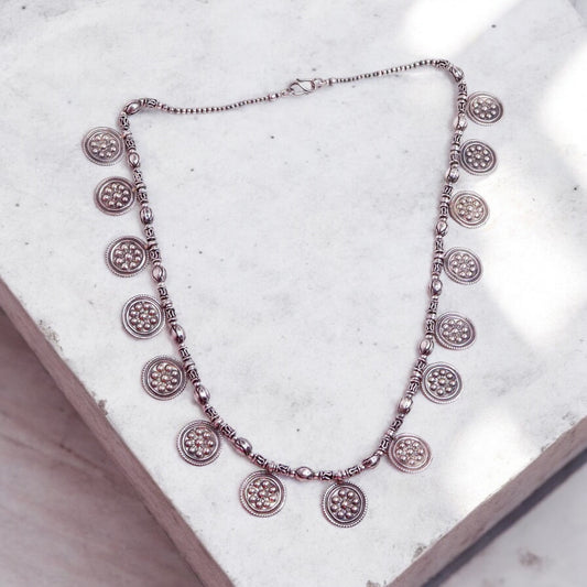 Striking oxidized silver necklace with detailed vintage-inspired patterns, offering a bold, unique look with a timeless, antique finish.
