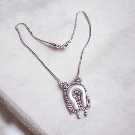 Beautiful oxidized silver necklace with intricate patterns and a vintage finish, offering a bold, antique look for statement styling.
