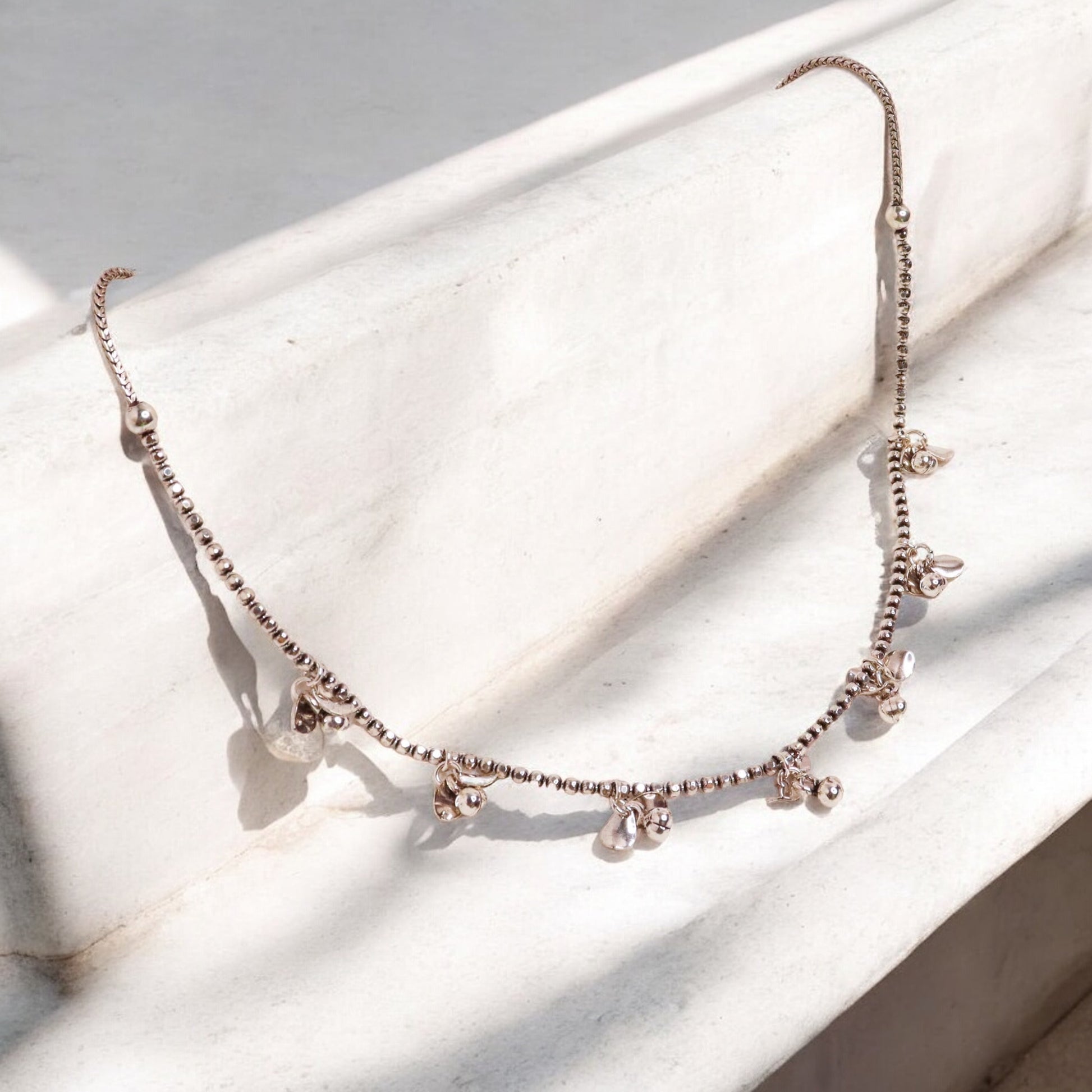 image of a delicate silver chain, showcasing its fine links and shiny, polished finish.