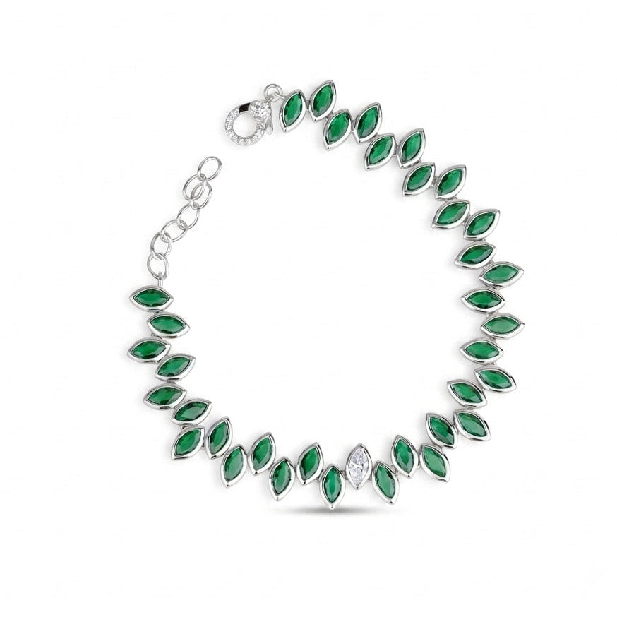 A silver tennis bracelet featuring marquise-cut green emeralds and a central clear marquise-cut stone, displayed on a clean white background.